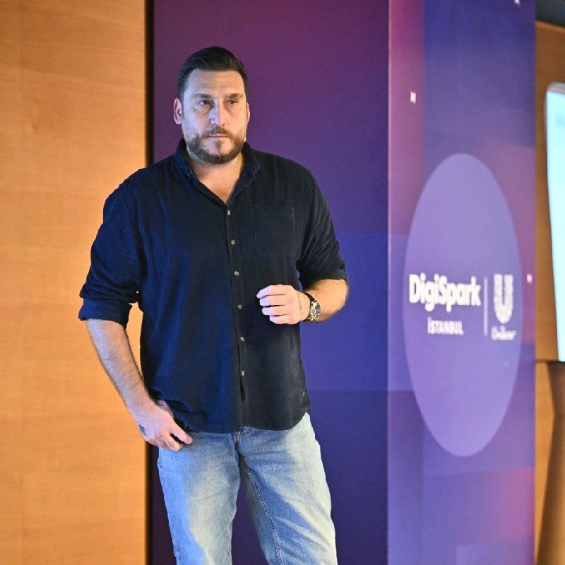 Levent Gençay speaking at a technology event